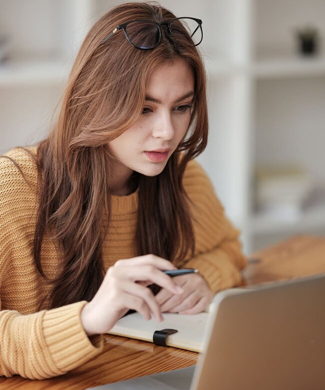 Teilnehmerin eines IHK-Zertifikatskurses lernt online am Laptop